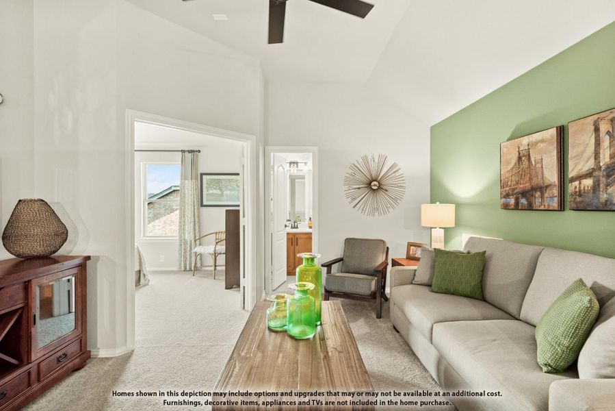 Living room with vaulted ceiling, green accent wall, gray sofa, and ceiling fan, open to bedroom and bathroom hallway. Living room with vaulted ceiling, green accent wall, gray sofa, and ceiling fan, open to bedroom and bathroom hallway.