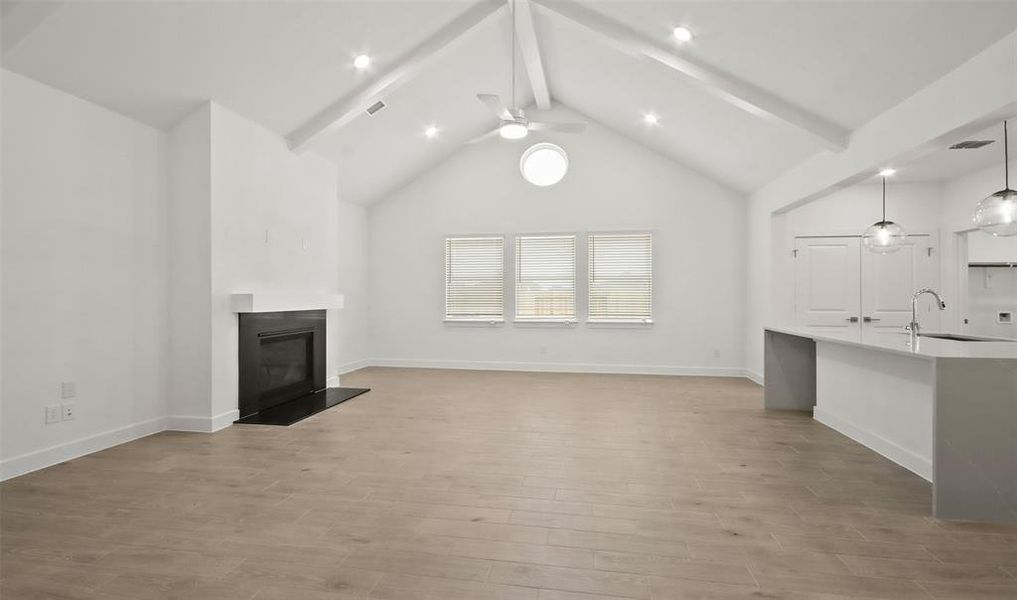 Cozy great room with high ceilings and fireplace