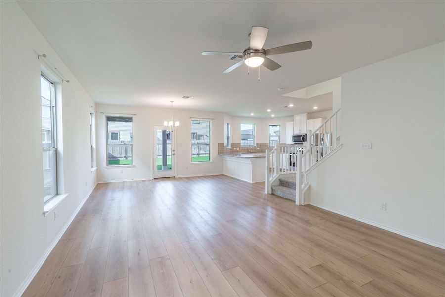 An open-concept main floor features durable wood flooring and ample natural illumination. An open-concept main floor features durable wood flooring and ample natural illumination.