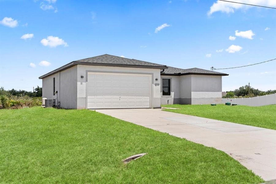 Front exterior of a new home in , Lehigh Acres, FL, highlighting curb appeal (Image 15).
