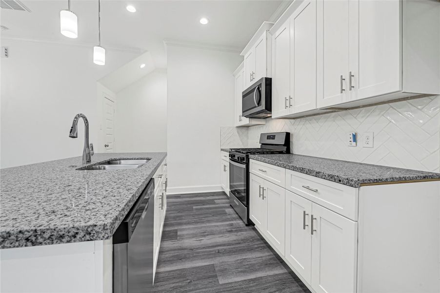 Modern kitchen with granite countertops, white cabinetry, and stainless steel appliances. Features a herringbone tile backsplash, a central island with a sink, and pendant lighting. Perfect for cooking and entertaining. Modern kitchen with granite countertops, white cabinetry, and stainless steel appliances. Features a herringbone tile backsplash, a central island with a sink, and pendant lighting. Perfect for cooking and entertaining.