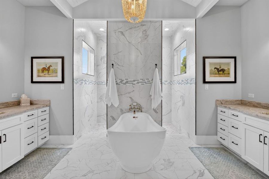 Step into the stunning primary bath that includes the walk-in shower, the deep, soaking tub, along with ample room for your storage needs.