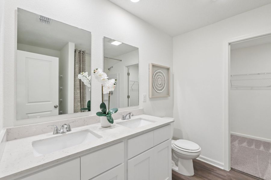 A bathroom with a sink toilet and mirror. A bathroom with a sink toilet and mirror.