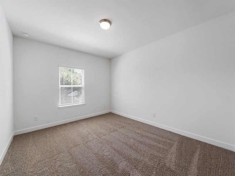 The third secondary bedroom is located at the end of the hallway opposite of the Primary Bedroom. (Sample photos of a completed Warwick floor plan. The image may feature alternative selections and/or upgrades.)