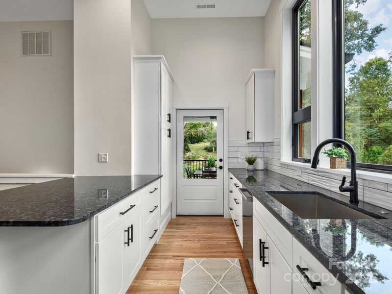 Kitchen flows effortlessly to front porch for convenient outdoor dining