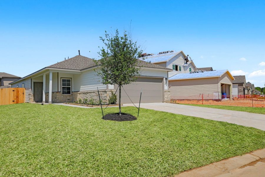 Front exterior of a new home in Lonestar Collection at Granger Pines, Conroe, TX, highlighting curb appeal (Image 1).