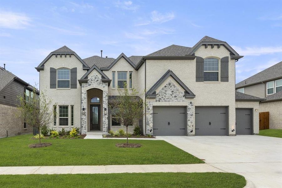 Front exterior of a new home in Woodcreek, Fate, TX, highlighting curb appeal (Image 2). Front exterior of a new home in Woodcreek, Fate, TX, highlighting curb appeal (Image 2).