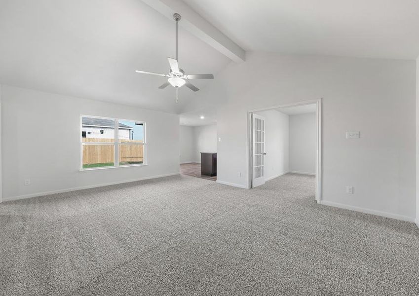 The family room has a large window with a view of the fully-fenced backyard.