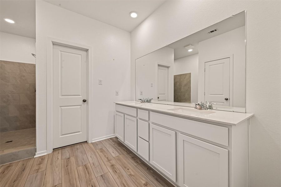 Well-appointed primary bath with dual vanities, generous storage, and a bright, clean design that makes daily routines feel effortless.