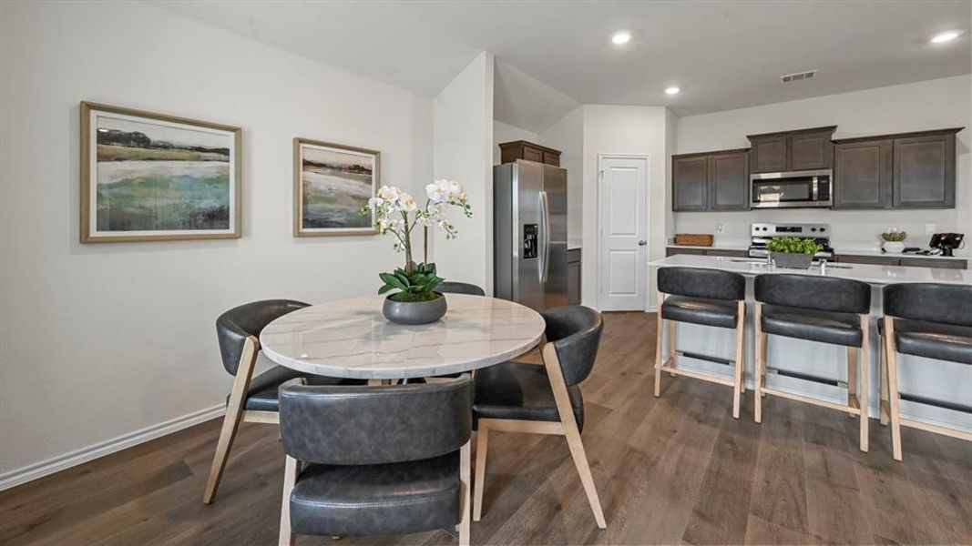 Dining space with dark wood-style floors and recessed lighting Dining space with dark wood-style floors and recessed lighting