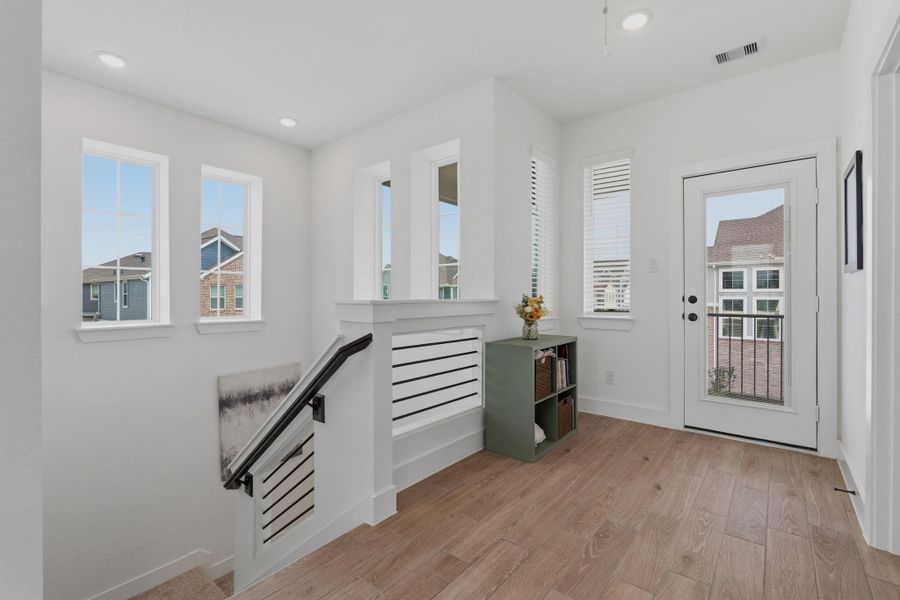 Upstairs landing leads to outdoor balcony.