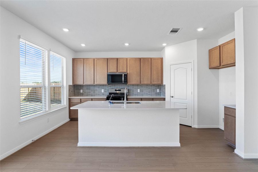 This spacious kitchen has it all—ample storage, generous counter space, and a layout that truly makes it the heart of the home. This spacious kitchen has it all—ample storage, generous counter space, and a layout that truly makes it the heart of the home.