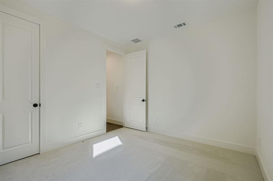 Unfurnished bedroom with light colored carpet Unfurnished bedroom with light colored carpet