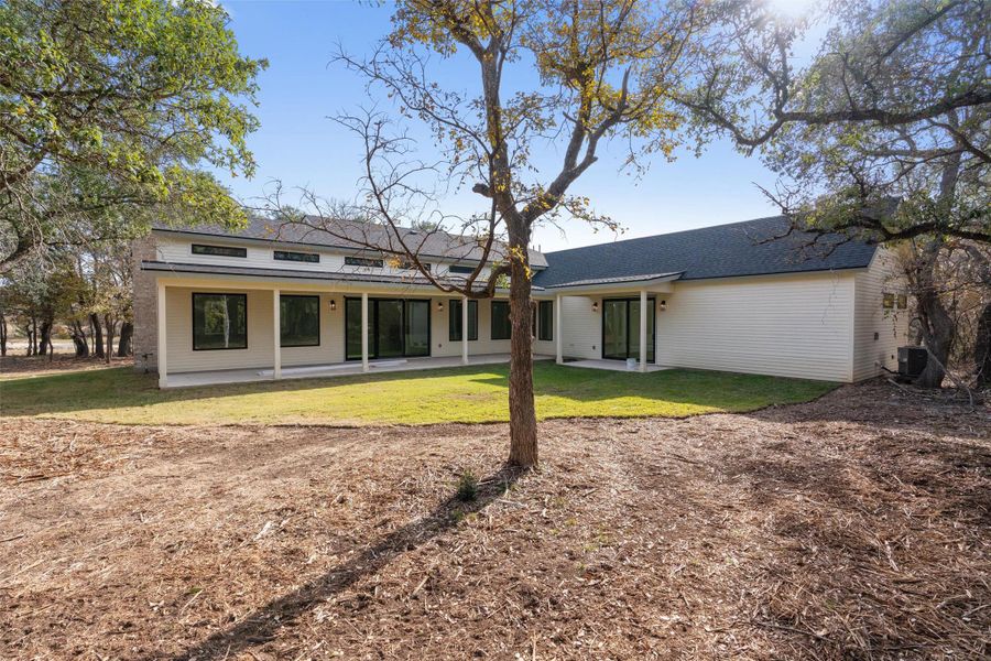 Rear view of property featuring a patio area and a yard Rear view of property featuring a patio area and a yard