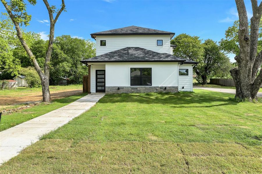 Back of property featuring a shingled roof and crawl space Back of property featuring a shingled roof and crawl space