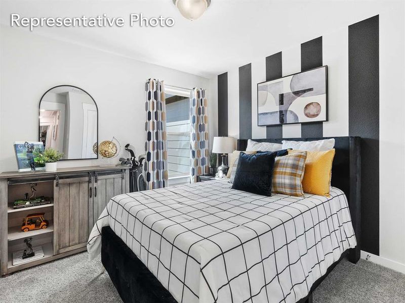 Bedroom featuring light carpet