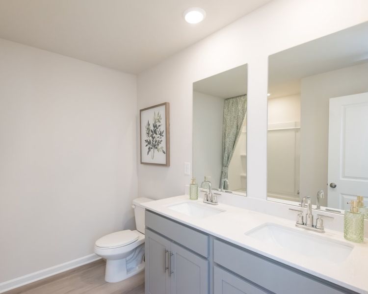 A spacious shared bathroom for two secondary bathrooms.