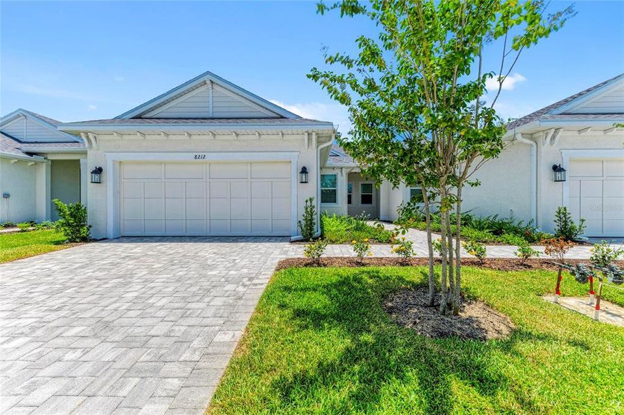 Front exterior of a new home in SeaFlower, Bradenton, FL, highlighting curb appeal (Image 2). Front exterior of a new home in SeaFlower, Bradenton, FL, highlighting curb appeal (Image 2).