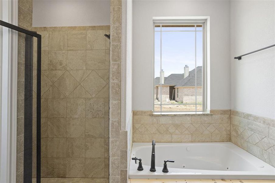 Bathroom featuring shower with separate bathtub