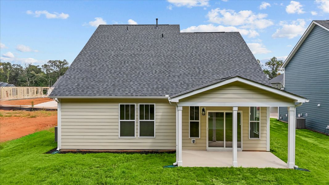 Rear covered porch creates a seamless extension of this home’s elegant design