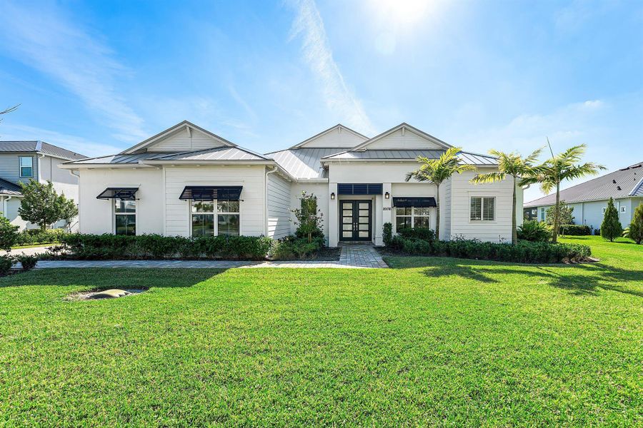 Front exterior of a new home in Bridgewater, Jupiter, FL, highlighting curb appeal (Image 25). Front exterior of a new home in Bridgewater, Jupiter, FL, highlighting curb appeal (Image 25).