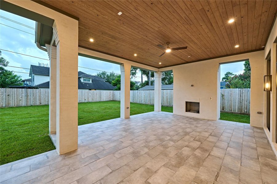 Expansive back porch off the living room offering an outdoor fire place and offering expanded space to enjoy.