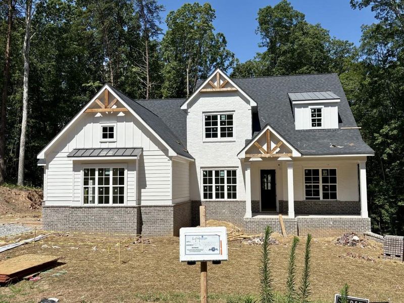 Front exterior of a new home in Arden on Lanier, Cumming, GA, highlighting curb appeal (Image 11). Front exterior of a new home in Arden on Lanier, Cumming, GA, highlighting curb appeal (Image 11).