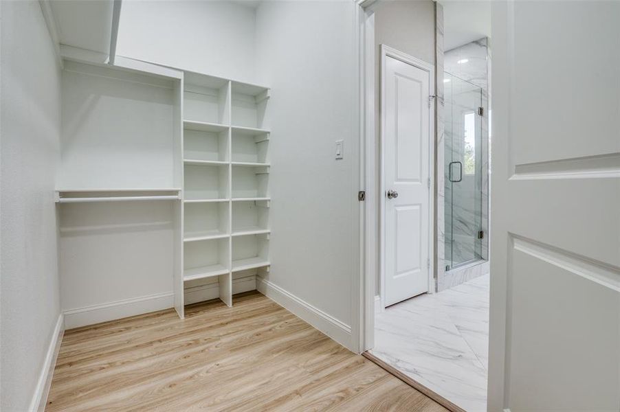 Walk in closet featuring light wood-style flooring