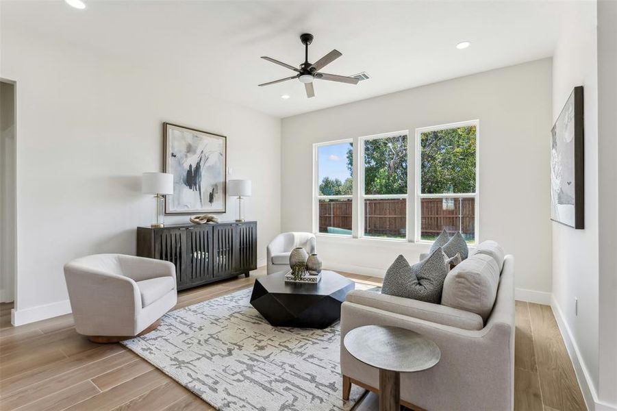 Living room with light wood-type flooring and ceiling fan