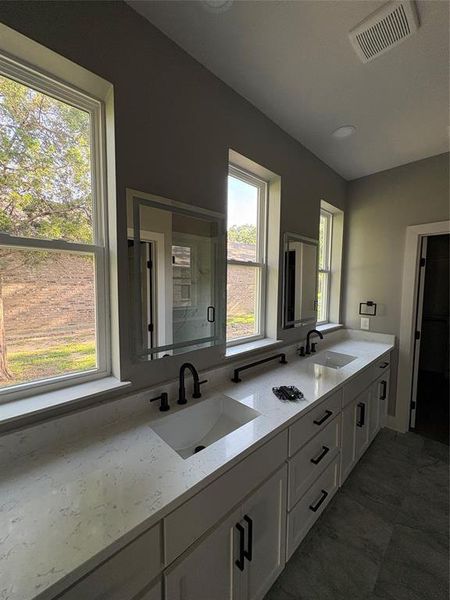 Bathroom with double vanity and healthy amount of natural light Bathroom with double vanity and healthy amount of natural light