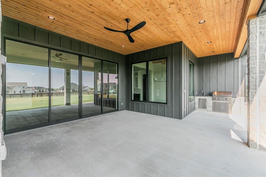 View of patio featuring exterior kitchen and ceiling fan