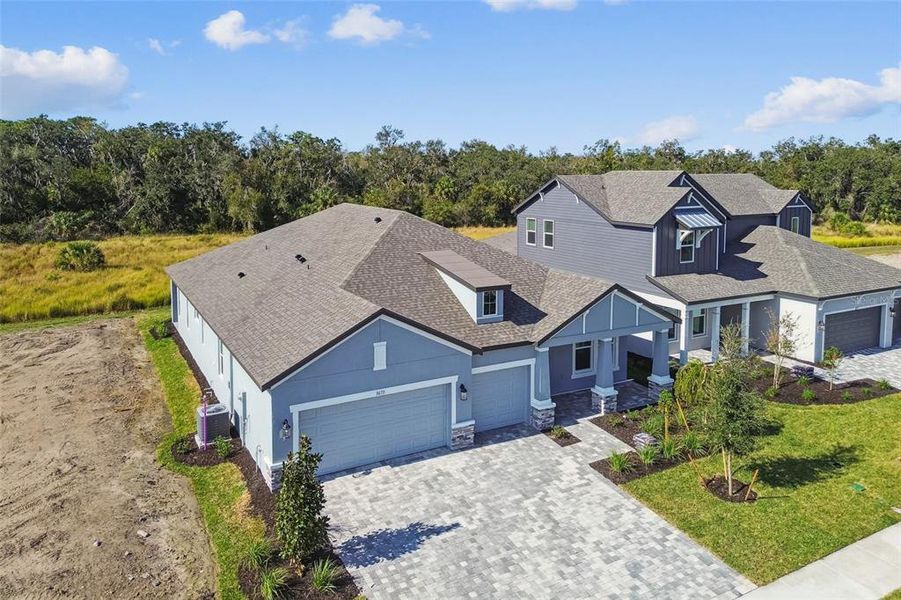 Front exterior of a new home in Creeks Edge at Twin Rivers, Parrish, FL, highlighting curb appeal (Image 29). Front exterior of a new home in Creeks Edge at Twin Rivers, Parrish, FL, highlighting curb appeal (Image 29).