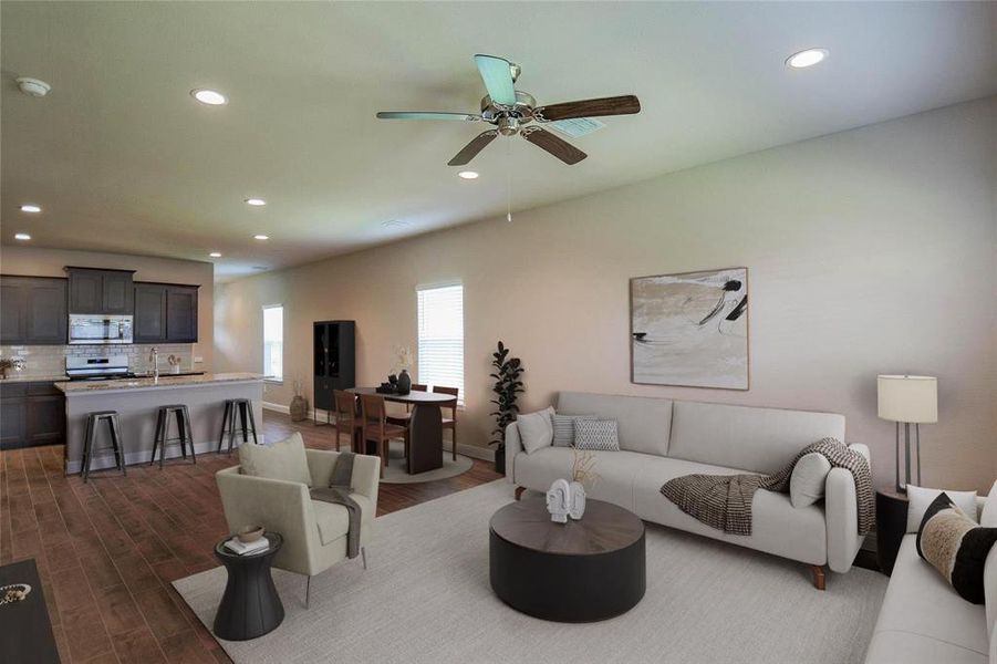 Living room featuring recessed lighting, dark wood-style flooring, and a ceiling fan Living room featuring recessed lighting, dark wood-style flooring, and a ceiling fan