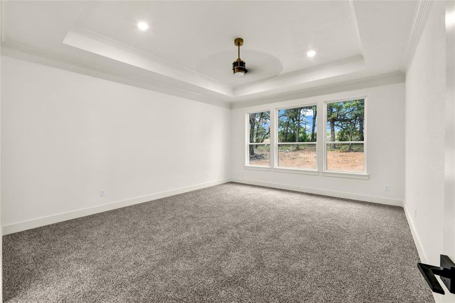 Carpeted empty room featuring a tray ceiling, ornamental molding, recessed lighting, and a ceiling fan Carpeted empty room featuring a tray ceiling, ornamental molding, recessed lighting, and a ceiling fan