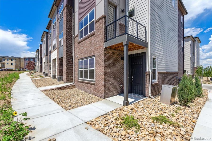 Front exterior of a new home in Townhome Collection at Grand Vue at Interlocken, Broomfield, CO, highlighting curb appeal (Image 2). Front exterior of a new home in Townhome Collection at Grand Vue at Interlocken, Broomfield, CO, highlighting curb appeal (Image 2).