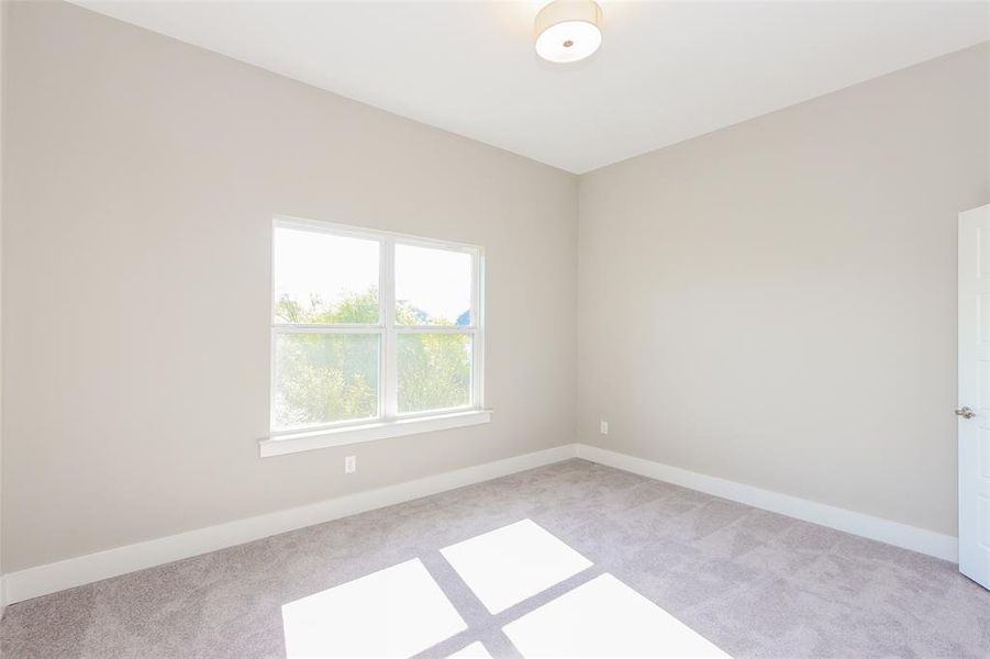 Unfurnished room with light colored carpet