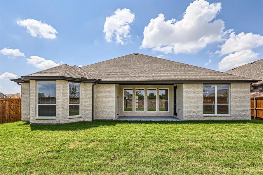 Rear view of house with a lawn