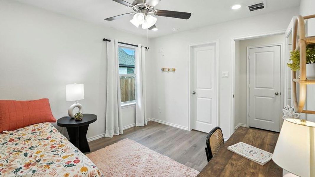 Bedroom with a ceiling fan, light wood finished floors, and recessed lighting Bedroom with a ceiling fan, light wood finished floors, and recessed lighting