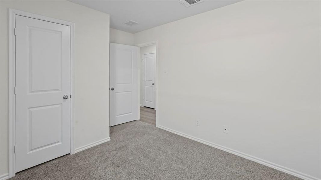 Unfurnished bedroom featuring baseboards and light colored carpet