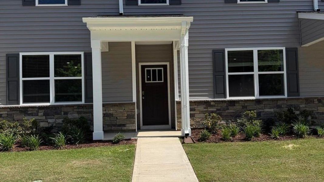 Exterior details and patio area of a home in Clock Road Townhomes, New Bern (Image 3).