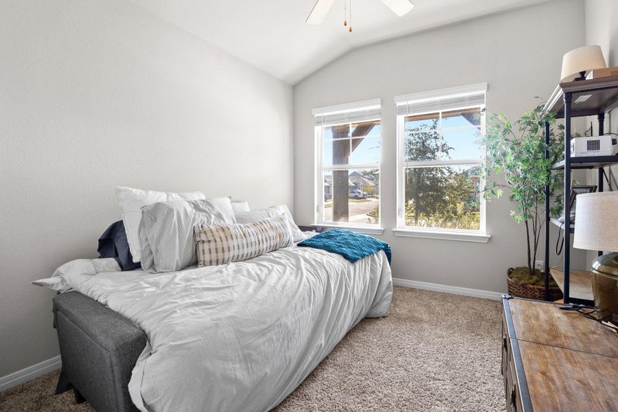 Bedroom with lofted ceiling, carpet, and ceiling fan Bedroom with lofted ceiling, carpet, and ceiling fan