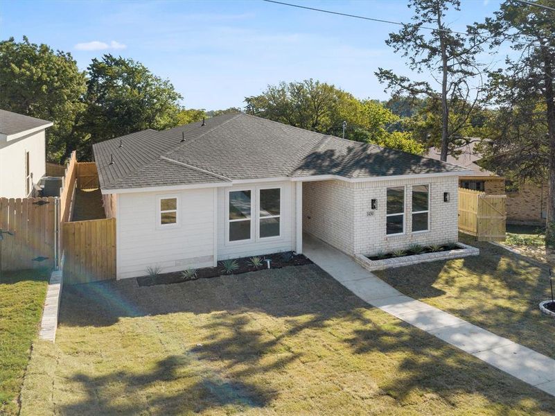 Single story home featuring a front lawn