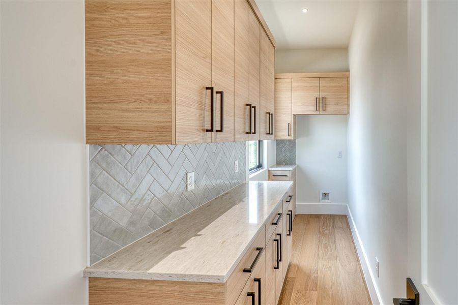 Oversized Butlers’ pantry w/cabinetry.  Space for an added refrigerator/freezer