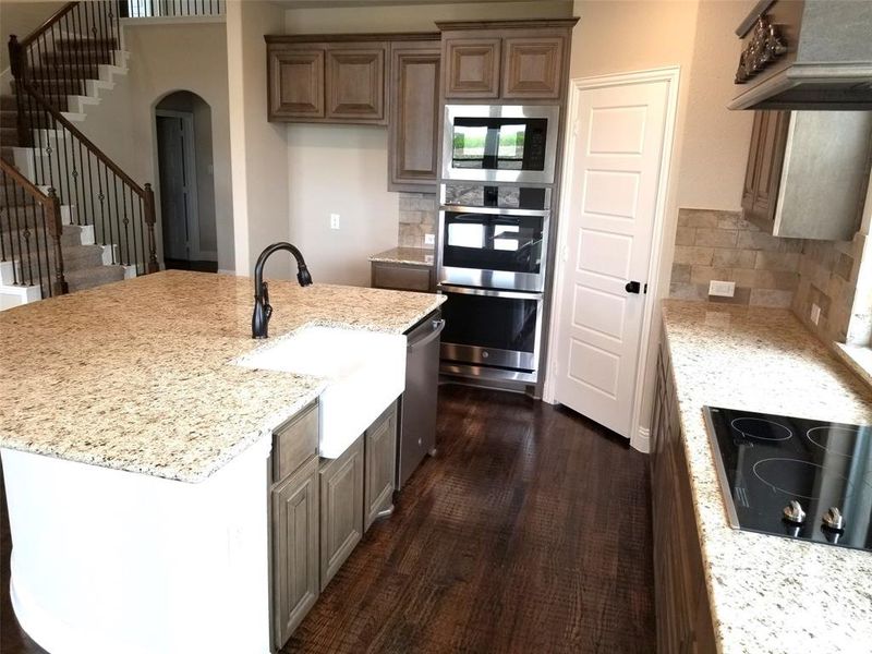 Kitchen features Giallo Verona granite and Saddle stained maple cabinets (Farm sink in photo not included)