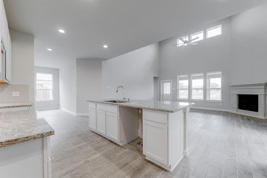 All of this overlooks your expansive family room, creating a perfect space for culinary delights and family gatherings. Sample photo of completed home with similar floor plan. As-built interior colors and selections may vary.