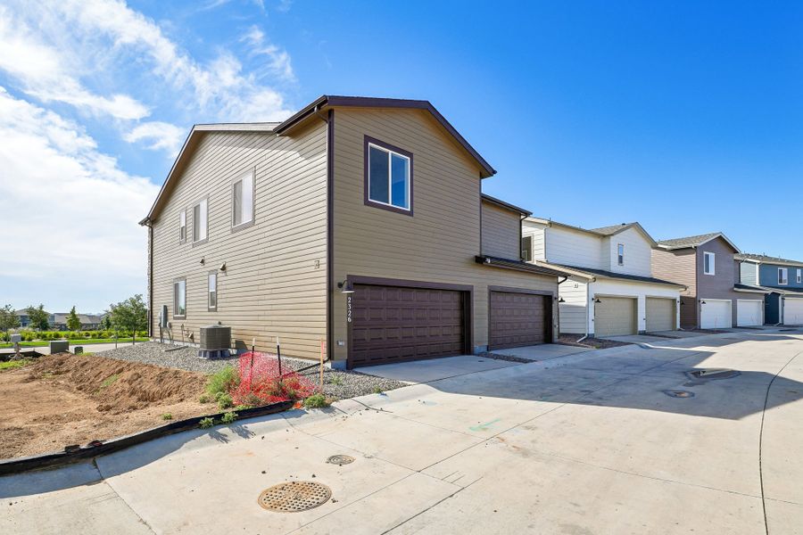 Front exterior of a new home in Pintail Commons at Johnstown Village, Johnstown, CO, highlighting curb appeal (Image 12).