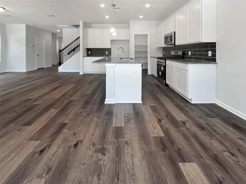 The Oriole II- Dining into the Kitchen. Home under construction, photo used for illustrative purposes only, colors and options will vary.