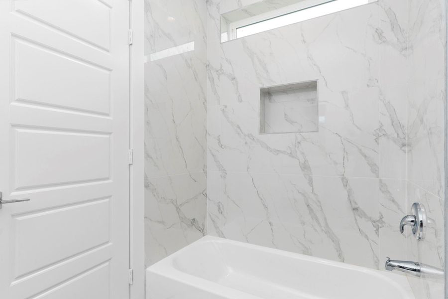 first floor en-suite bath features a shower/tub combo.