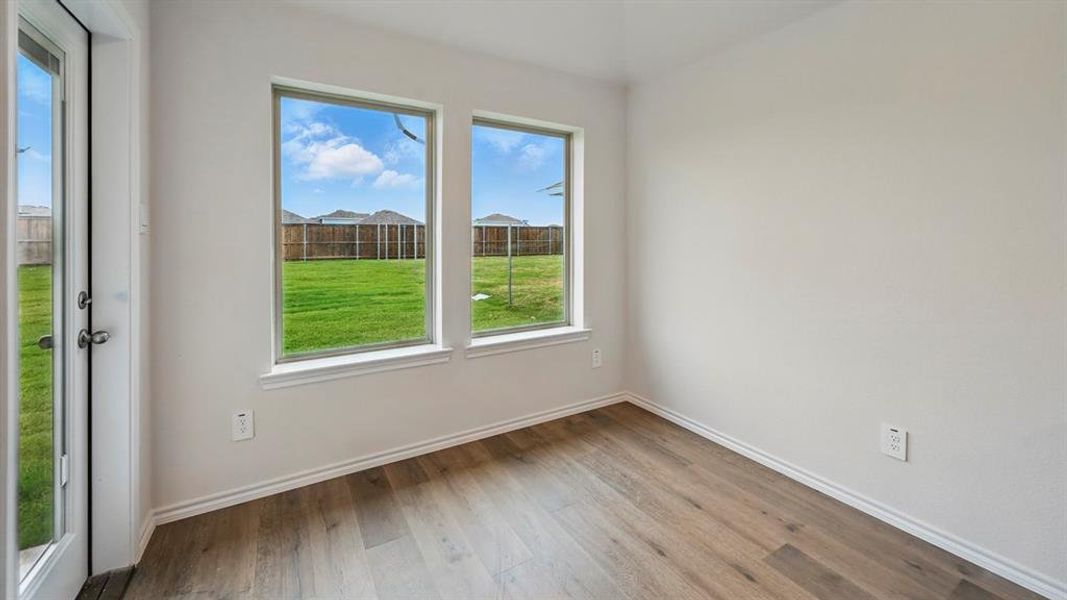 Empty room with baseboards and light wood-style floors