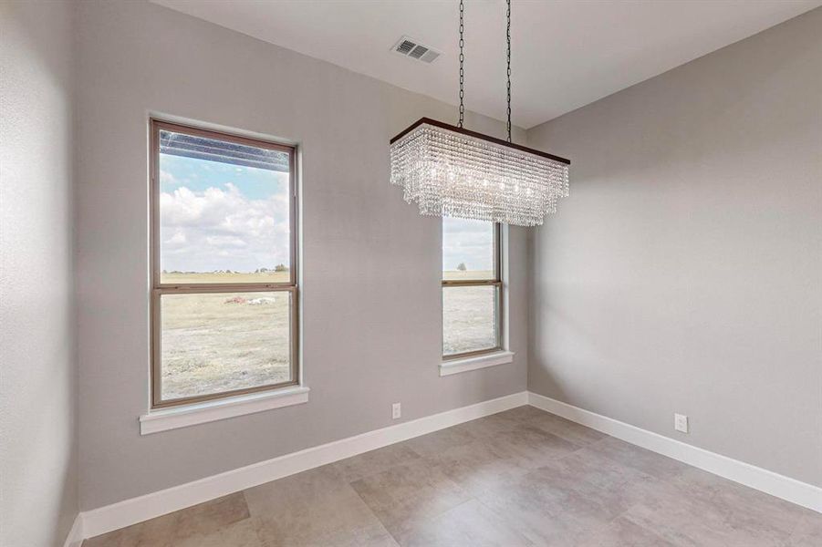 Unfurnished room with an inviting chandelier